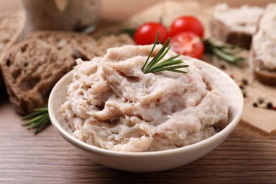 Photo of Delicious lard spread in bowl on wooden table, closeup