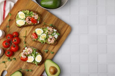 Photo of Delicious sandwiches with guacamole, shrimps and tomatoes on white table, flat lay. Space for text