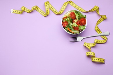 Photo of Bowl of fresh vegetable salad, fork and measuring tape on violet background, flat lay with space for text. Healthy diet concept