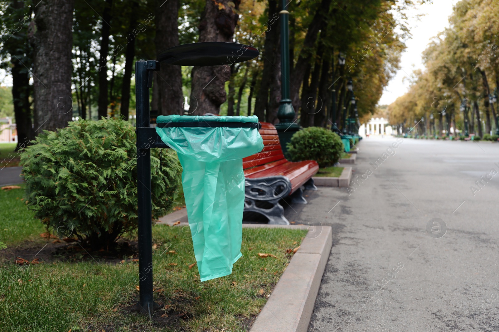 Photo of Eco bag for garbage in park on autumn day