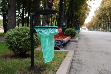 Eco bag for garbage in park on autumn day