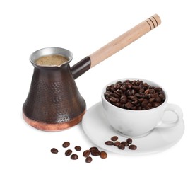 Photo of Metal turkish coffee pot with hot drink and beans on white background