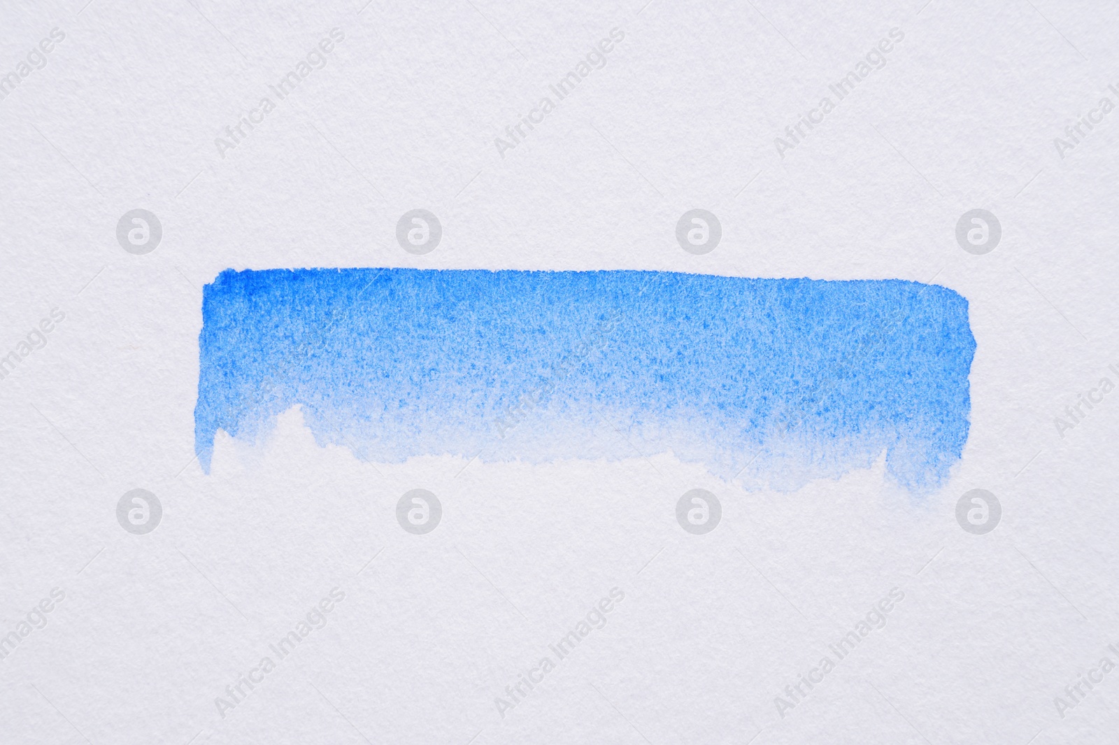 Photo of Stroke of blue watercolor paint on white background, top view
