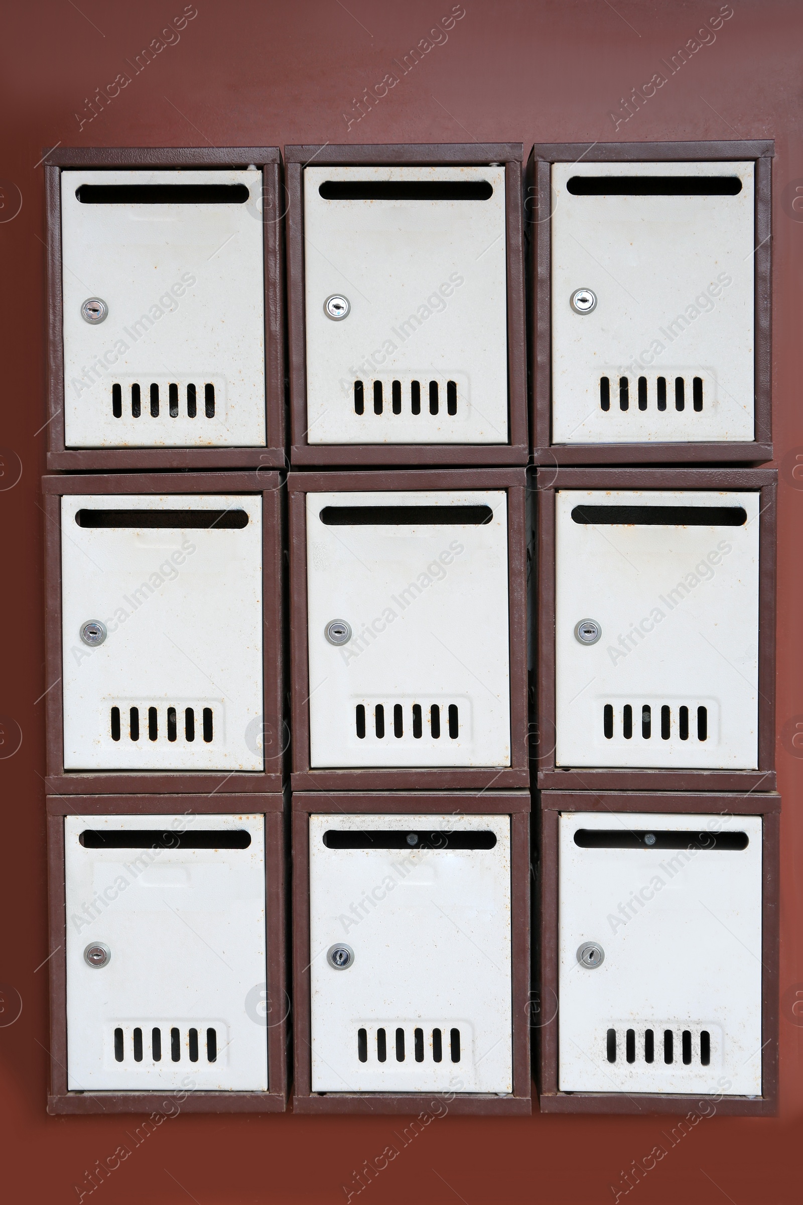 Photo of Many metal letter boxes on brown wall