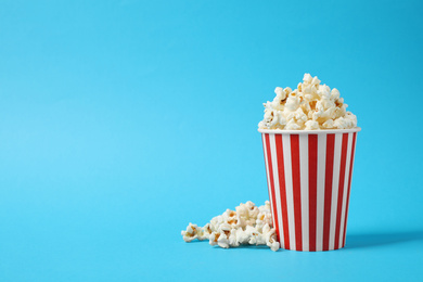 Delicious popcorn on light blue background. Space for text