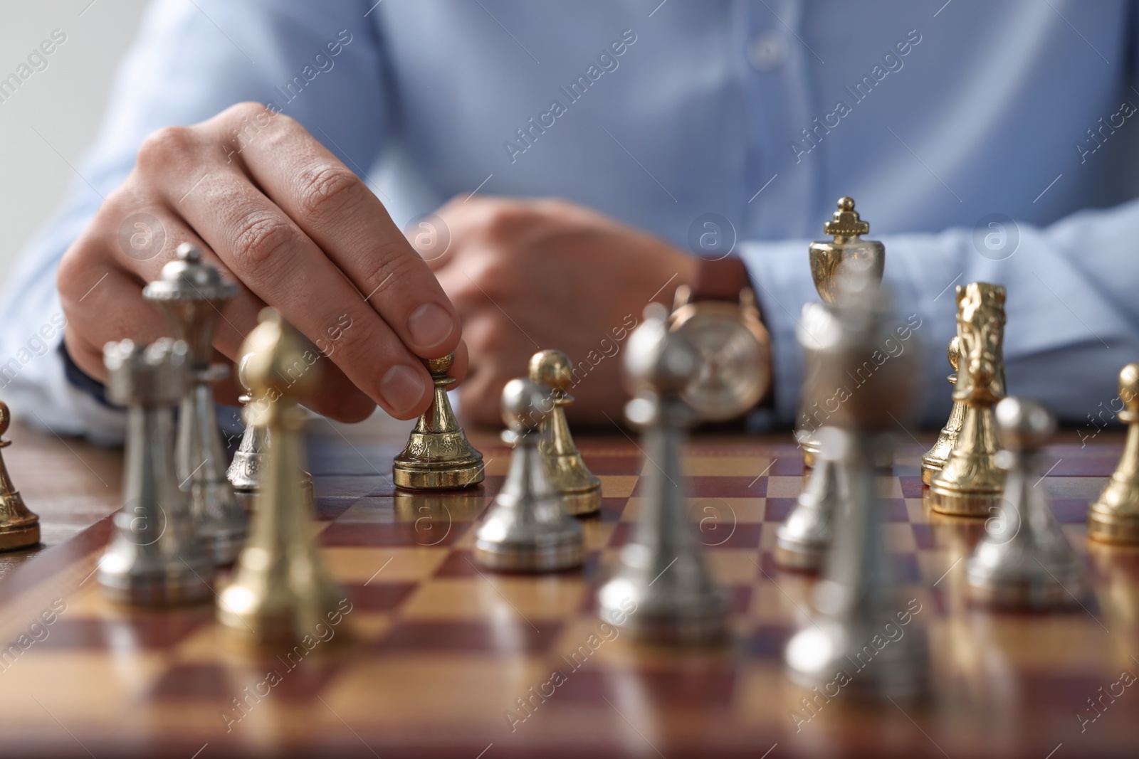 Photo of Man playing chess during tournament at chessboard, closeup