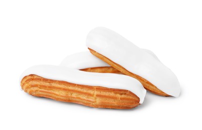 Photo of Three delicious eclairs covered with glaze isolated on white