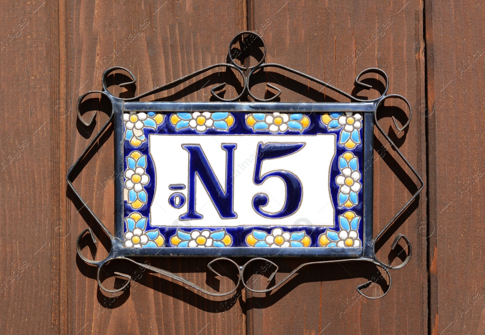 Photo of Plate with number five on wooden door