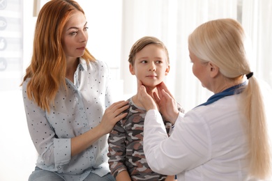 Mother with child visiting doctor in hospital