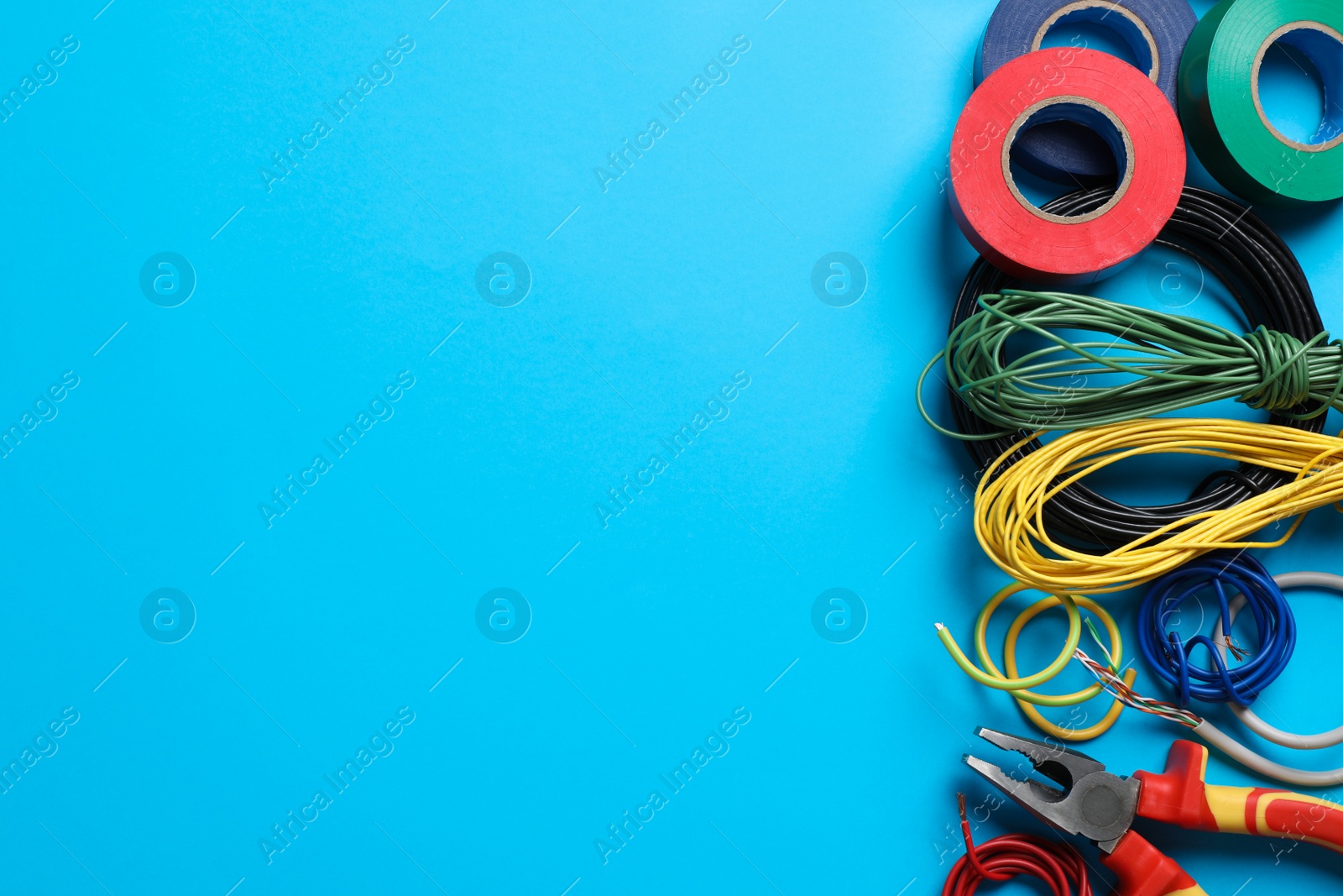 Photo of Flat lay composition with electrician's accessories on light blue background, space for text