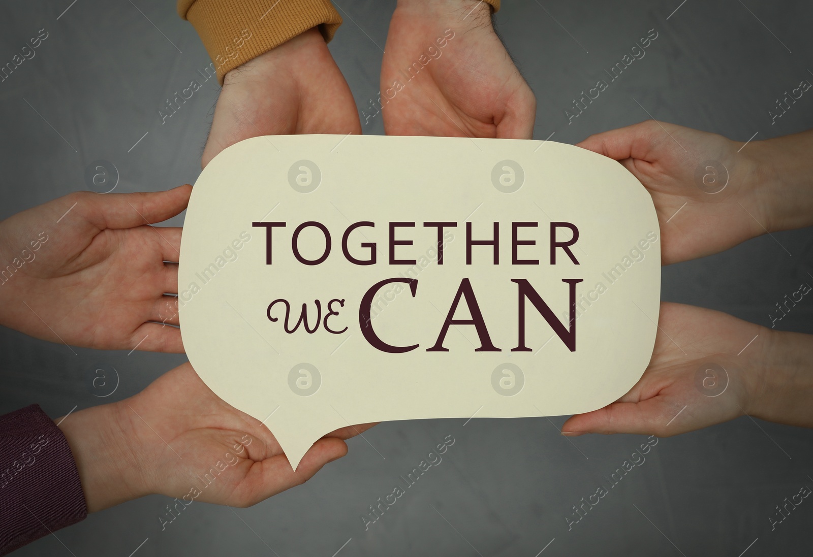 Image of Partnership, union and cooperation. People holding paper speech bubble with text Together We Can, closeup