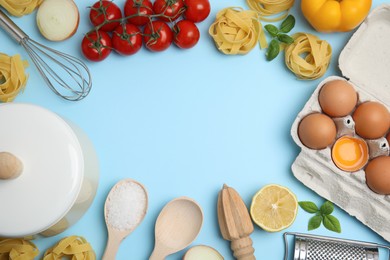 Photo of Frame made of cooking utensils and fresh ingredients on light blue background, flat lay. Space for text