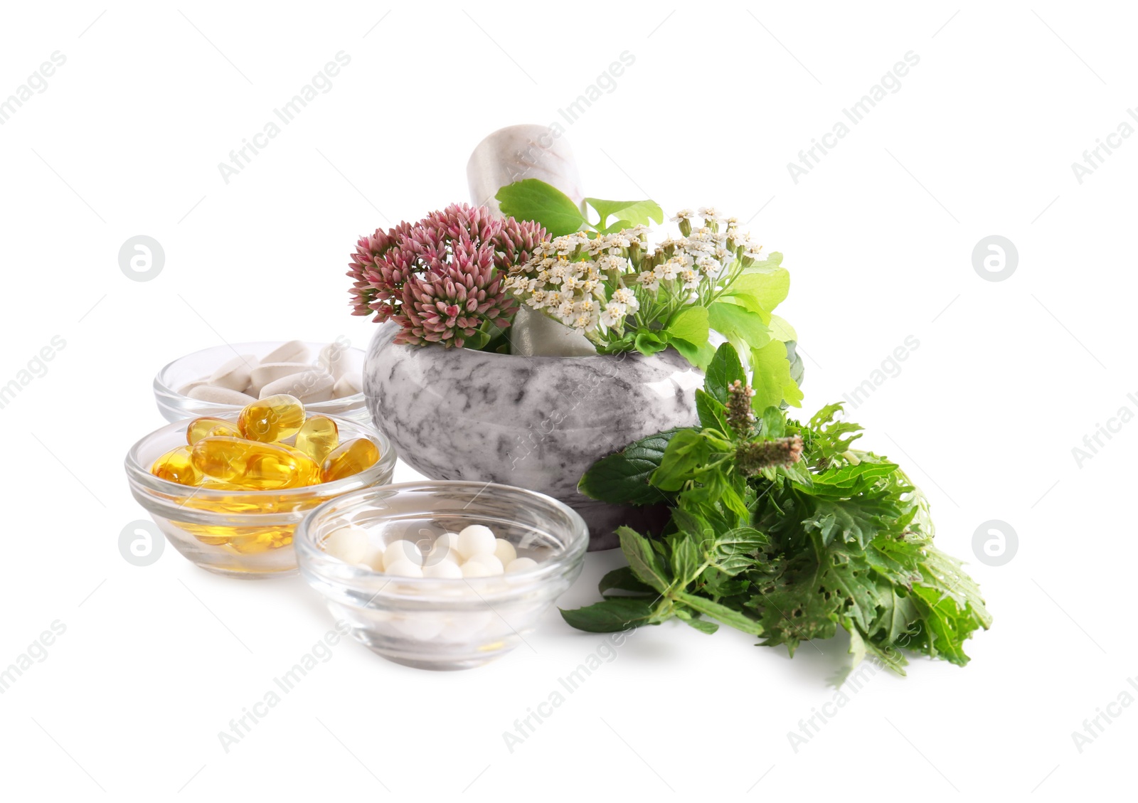 Photo of Marble mortar with fresh herbs and pills on white background