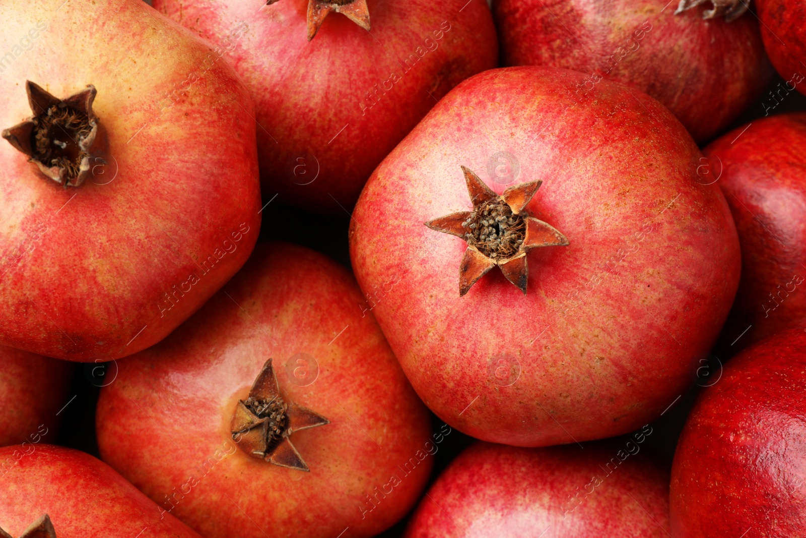 Photo of Fresh ripe pomegranates as background, top view