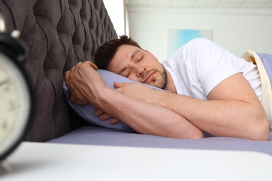 Photo of Handsome man sleeping on pillow at home. Bedtime