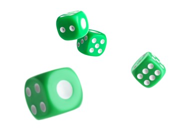 Four green dice in air on white background