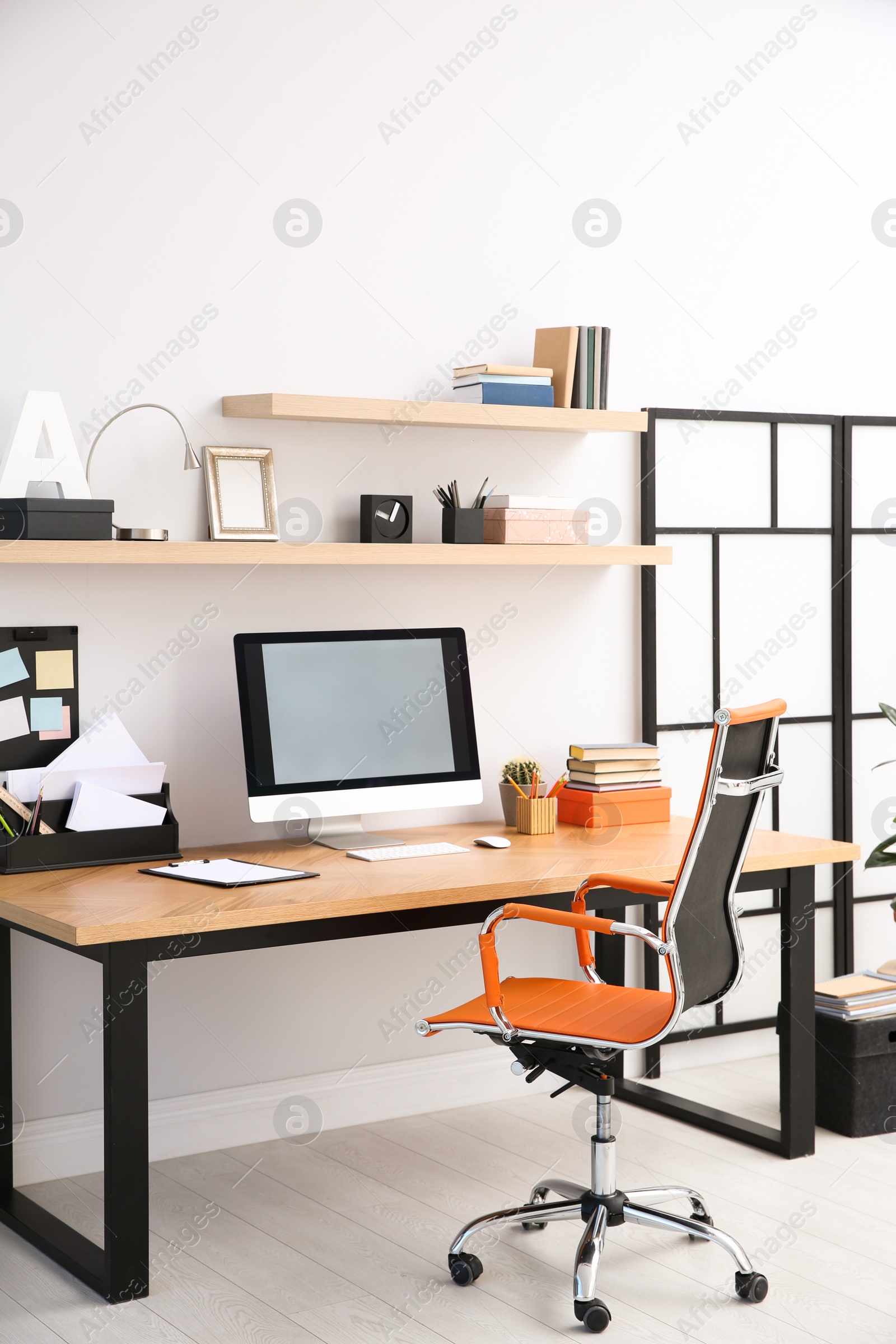 Photo of Modern computer on table in office interior. Stylish workplace