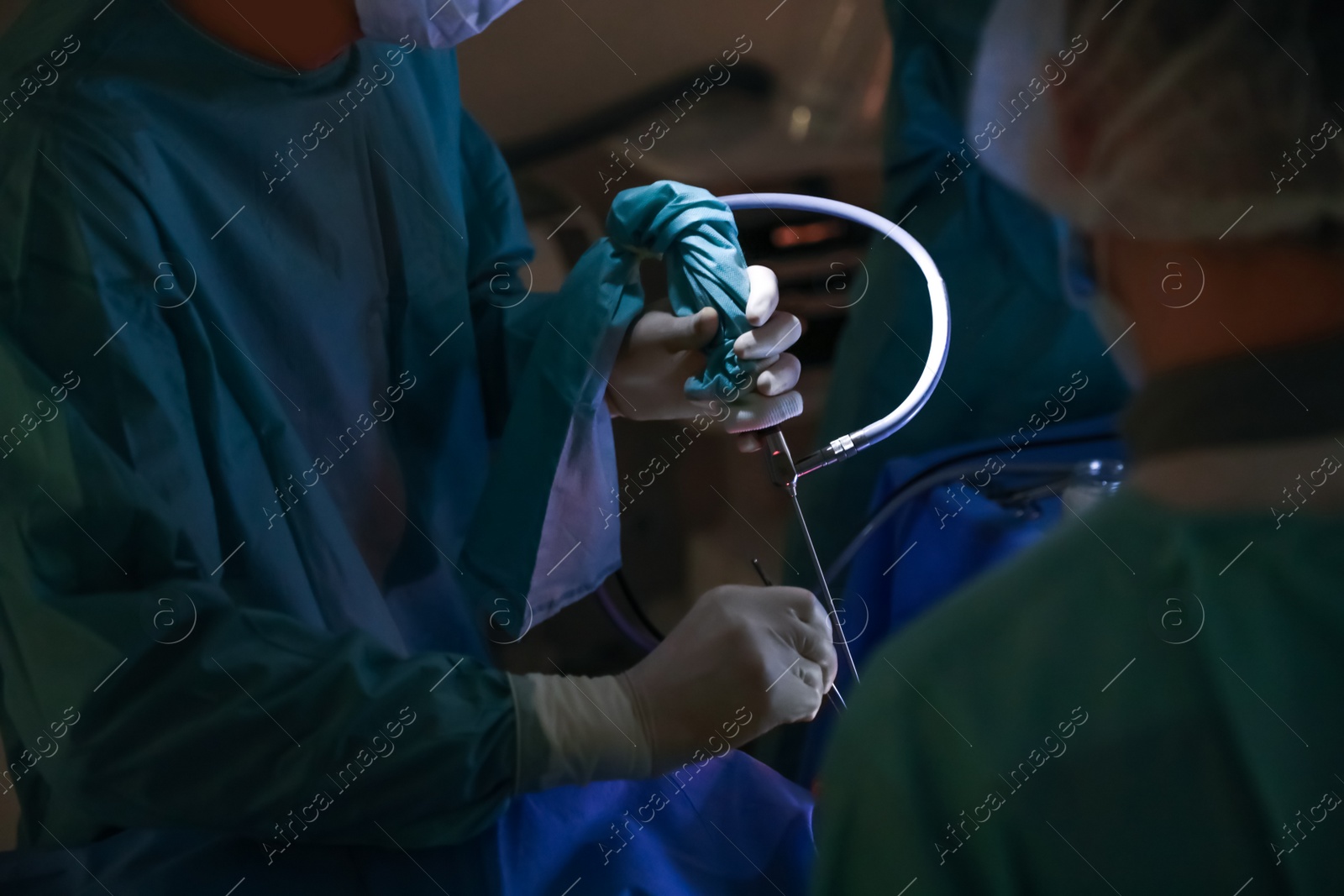 Photo of Professional doctors performing 
operation in surgery room, closeup