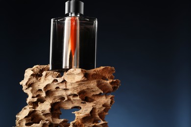 Photo of Luxury men`s perfume in bottle against dark background, space for text