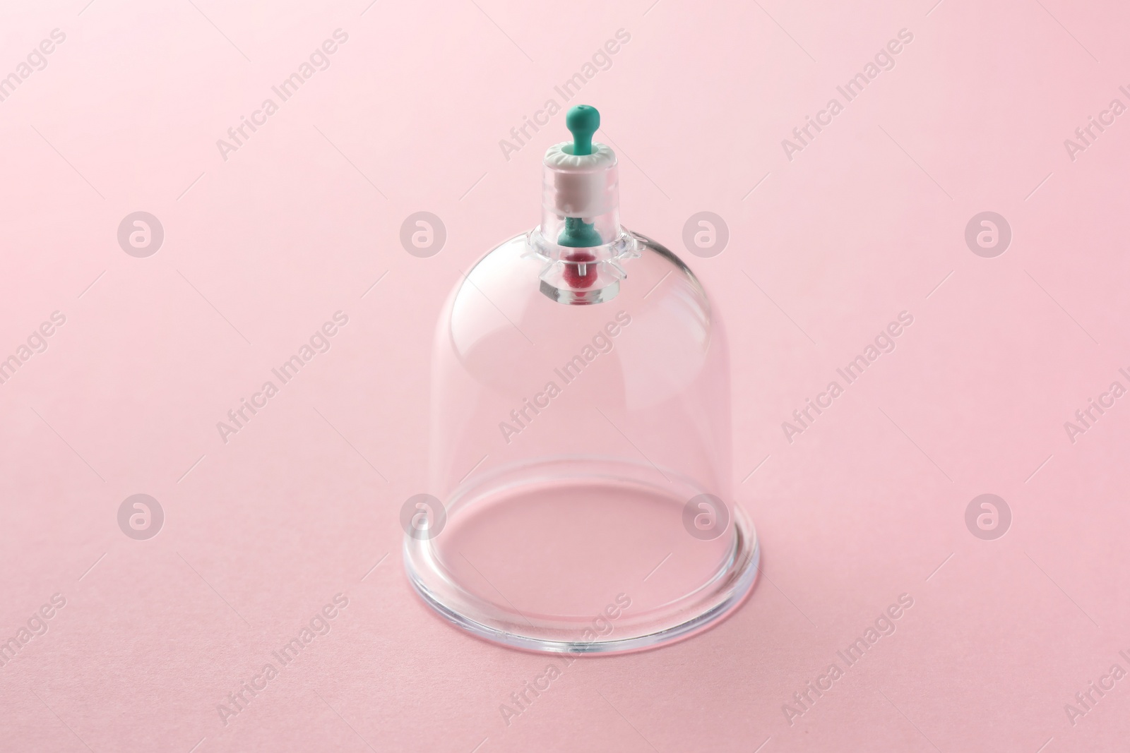 Photo of Plastic cup on pink background. Cupping therapy