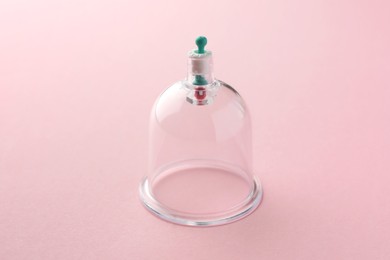 Photo of Plastic cup on pink background. Cupping therapy