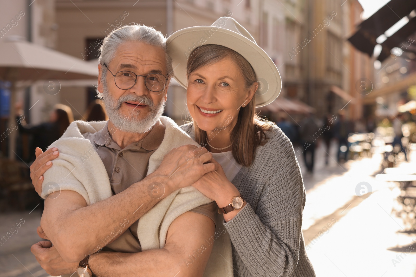 Photo of Affectionate senior couple walking outdoors, space for text