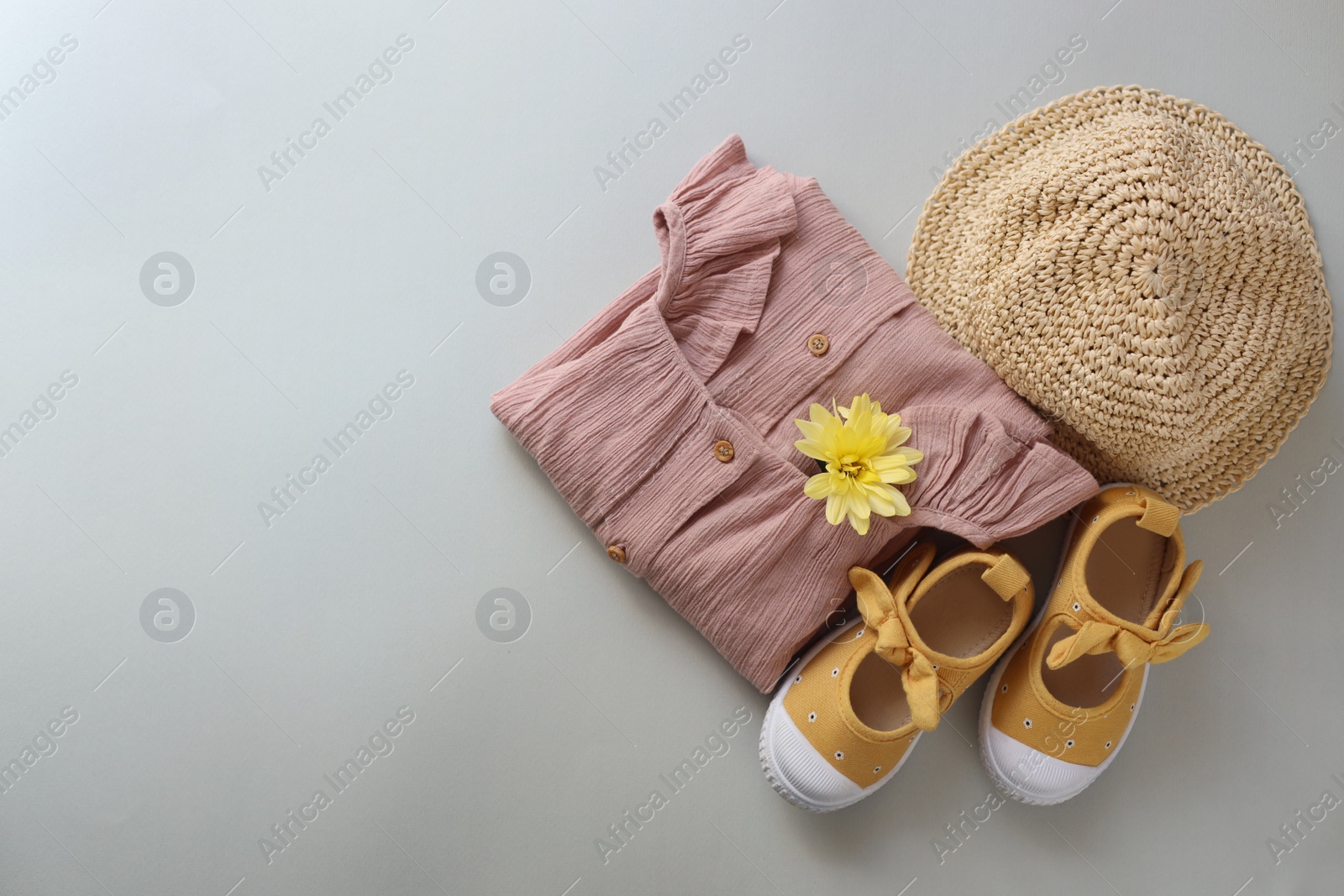 Photo of Stylish child clothes, shoes and hat on grey background, flat lay. Space for text