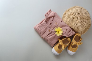 Stylish child clothes, shoes and hat on grey background, flat lay. Space for text