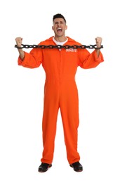 Emotional prisoner in orange jumpsuit with chained hands on white background