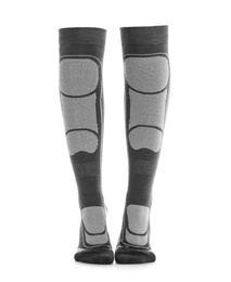 Photo of Woman wearing thermal knee socks on white background, closeup of legs. Winter sport clothes