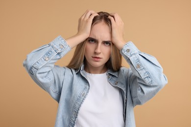 Photo of Portrait of resentful woman on beige background