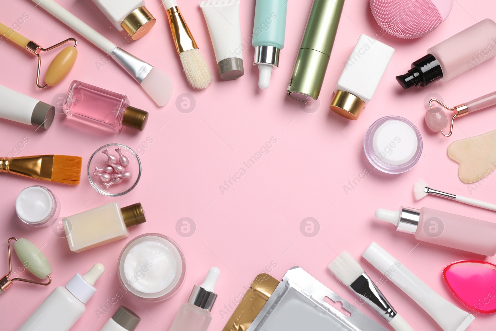 Photo of Frame of different skin care products on pink background, flat lay. Space for text