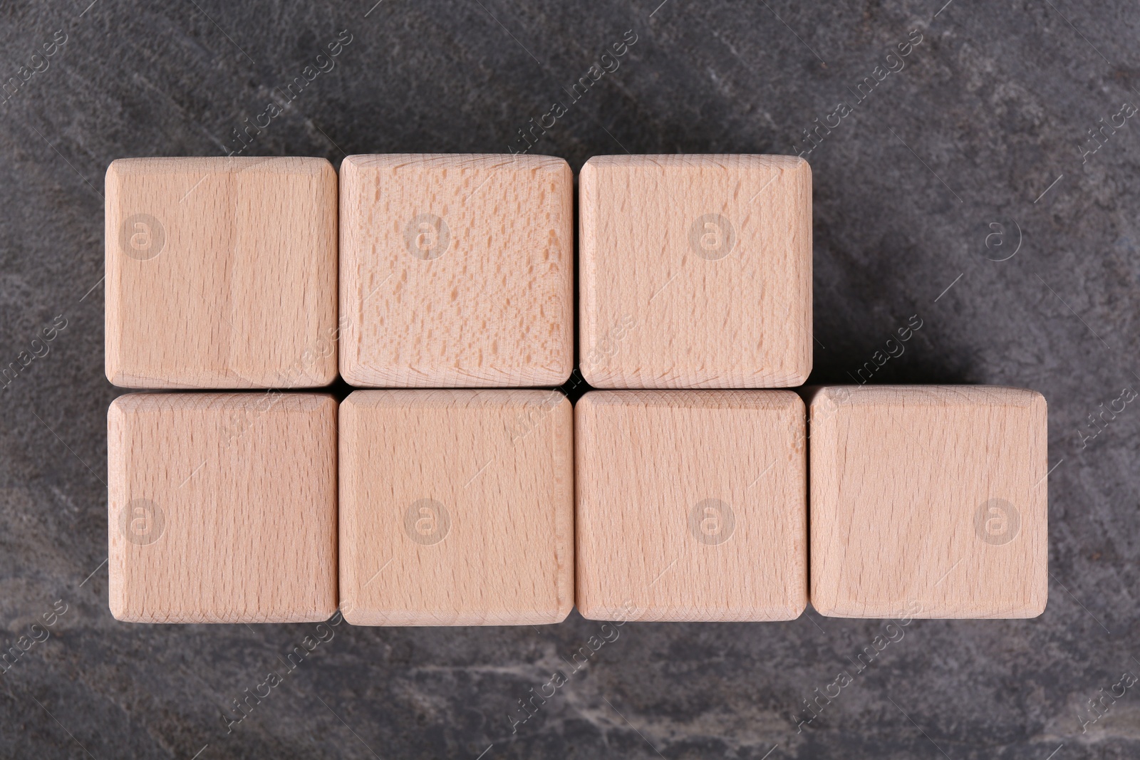 Photo of International Organization for Standardization. Cubes with abbreviation ISO 9001 on gray textured table, top view