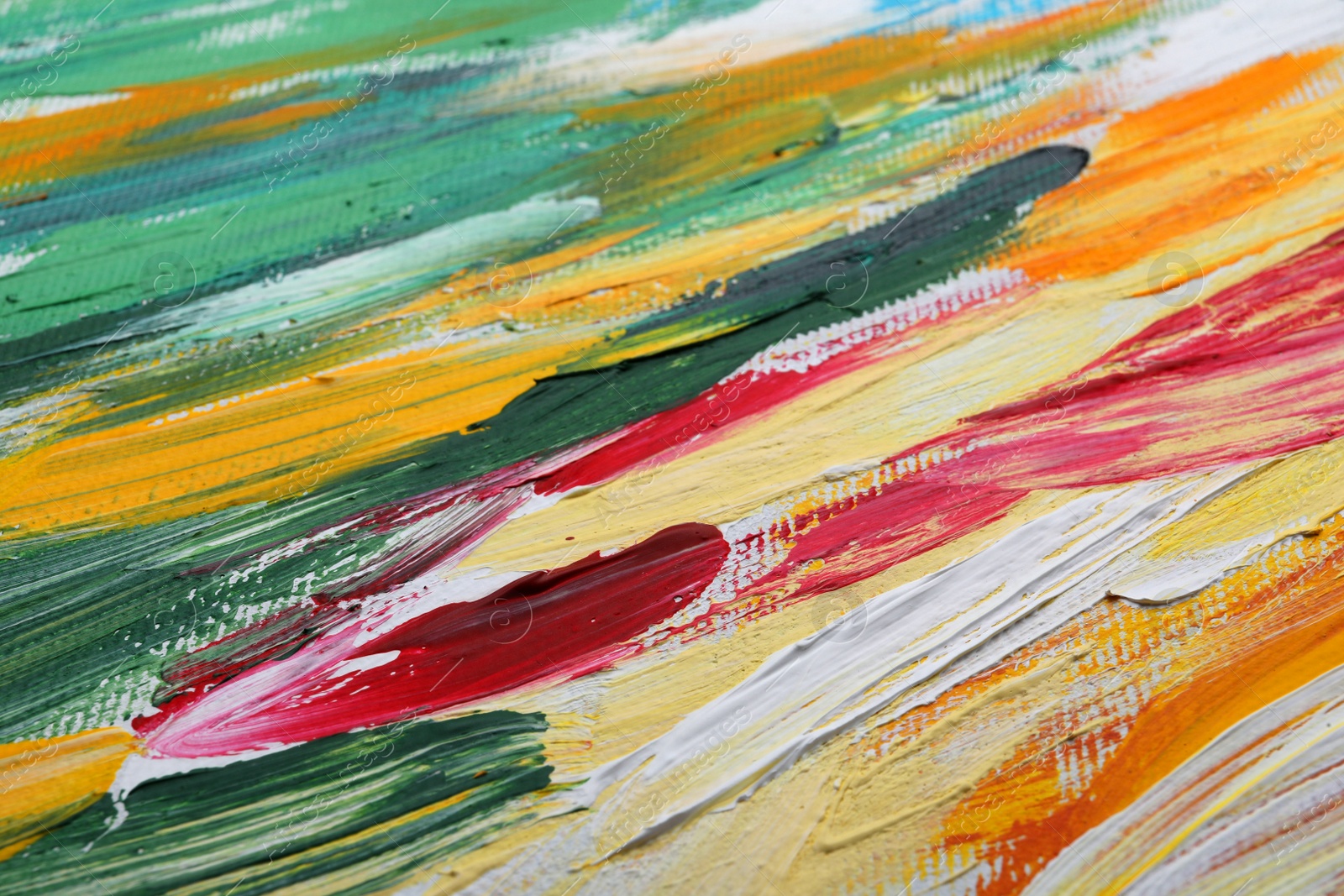 Photo of Beautiful strokes of colorful oil paints on white canvas as background, closeup