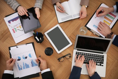 Photo of Businesspeople having meeting at table, top view. Management consulting