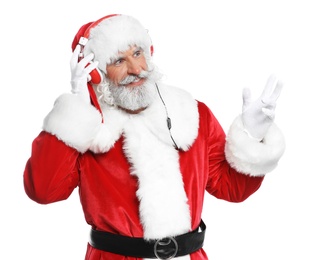 Santa Claus listening to Christmas music on white background