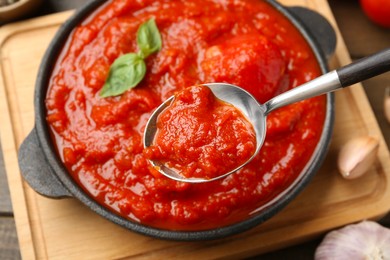 Photo of Eating homemade tomato sauce at table, closeup