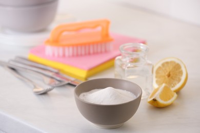 Baking soda, lemon and vinegar on white table. Eco friendly detergents