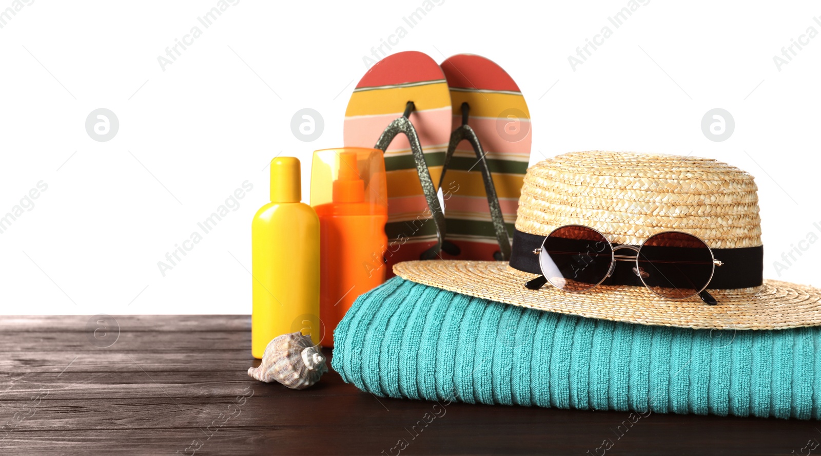 Photo of Composition with different beach objects on wooden table, white background