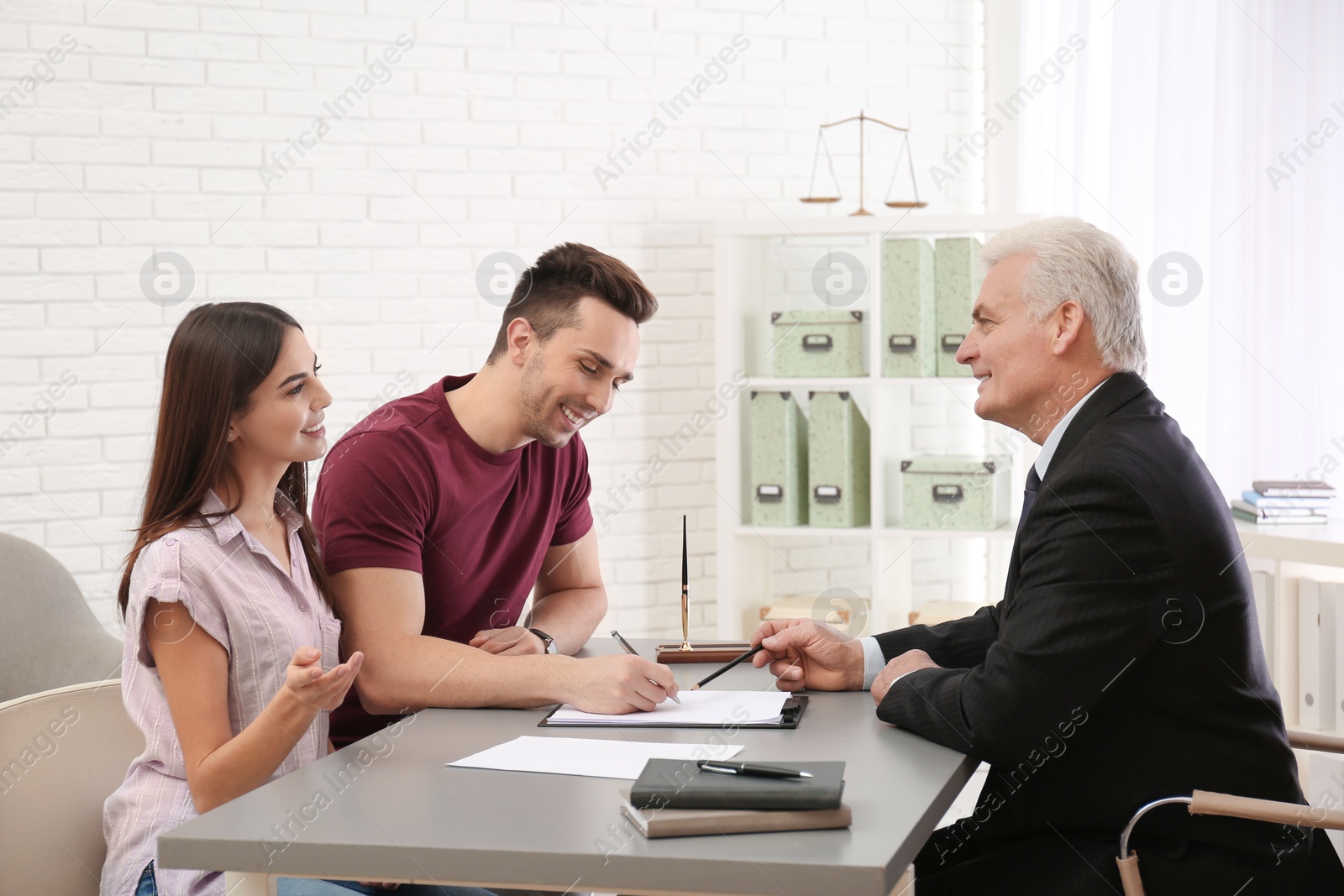 Photo of Lawyer having meeting with young couple in office