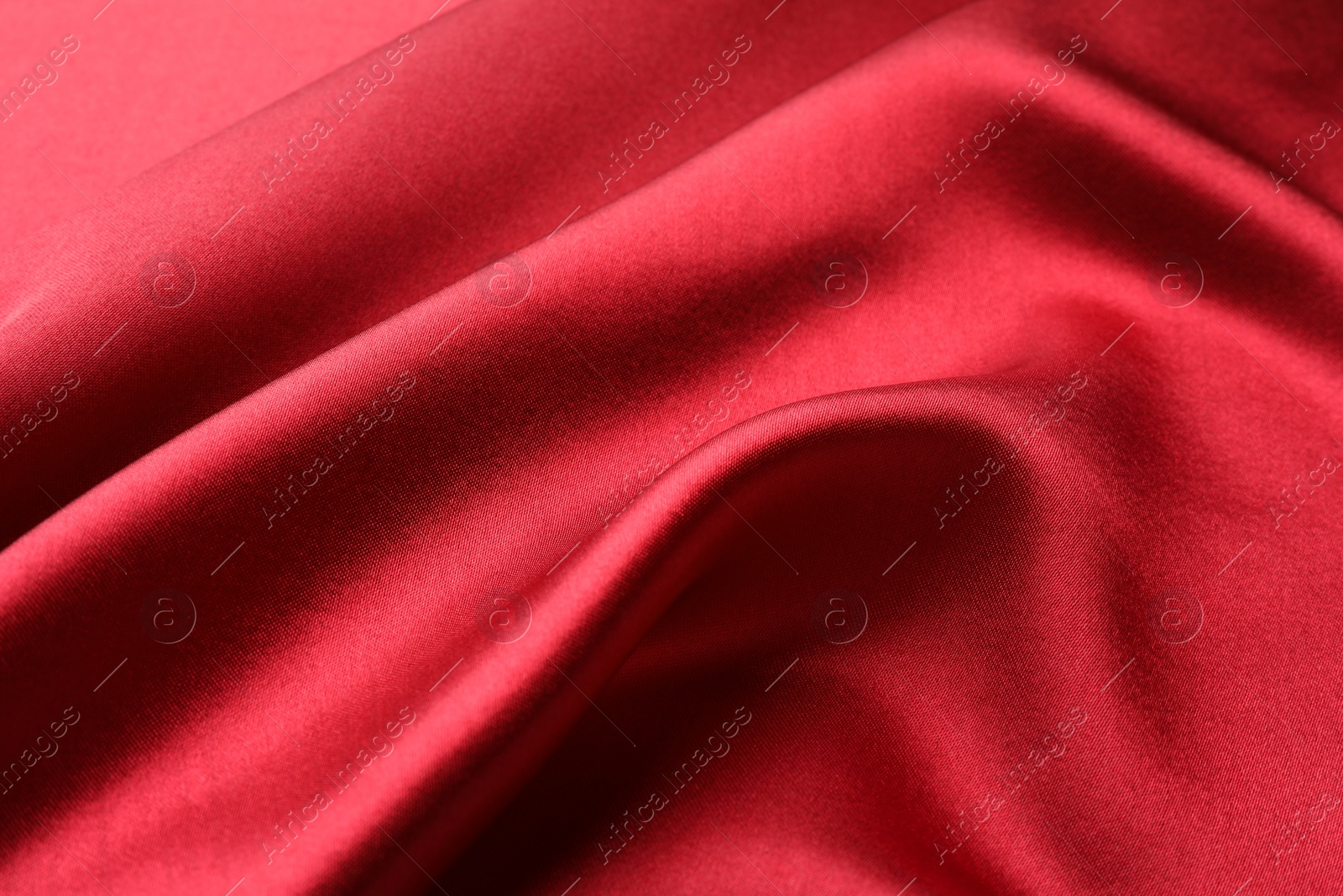 Photo of Texture of beautiful red silk fabric as background, closeup