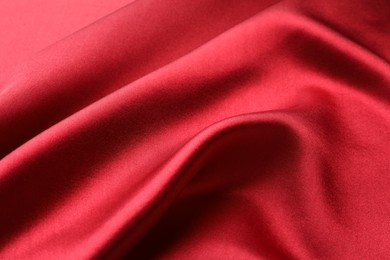 Photo of Texture of beautiful red silk fabric as background, closeup