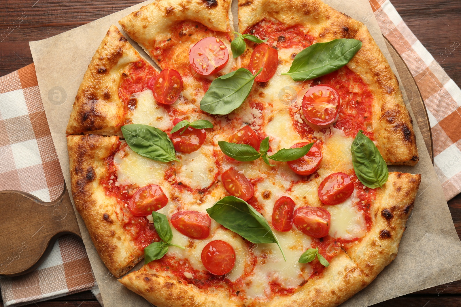 Photo of Delicious Margherita pizza on wooden table, top view