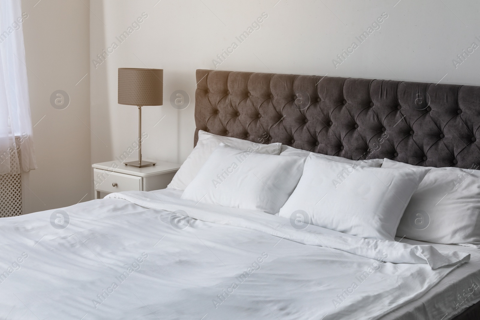 Photo of Soft white pillows on comfortable bed indoors