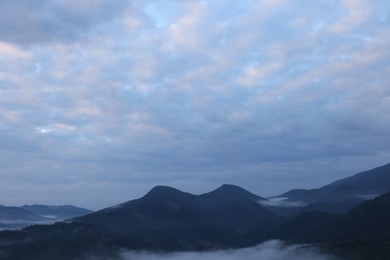 Photo of Picturesque view of mountains covered with fog