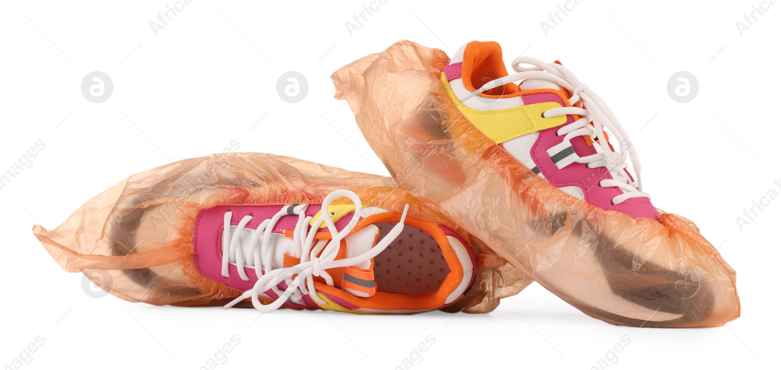 Photo of Sneakers in shoe covers isolated on white