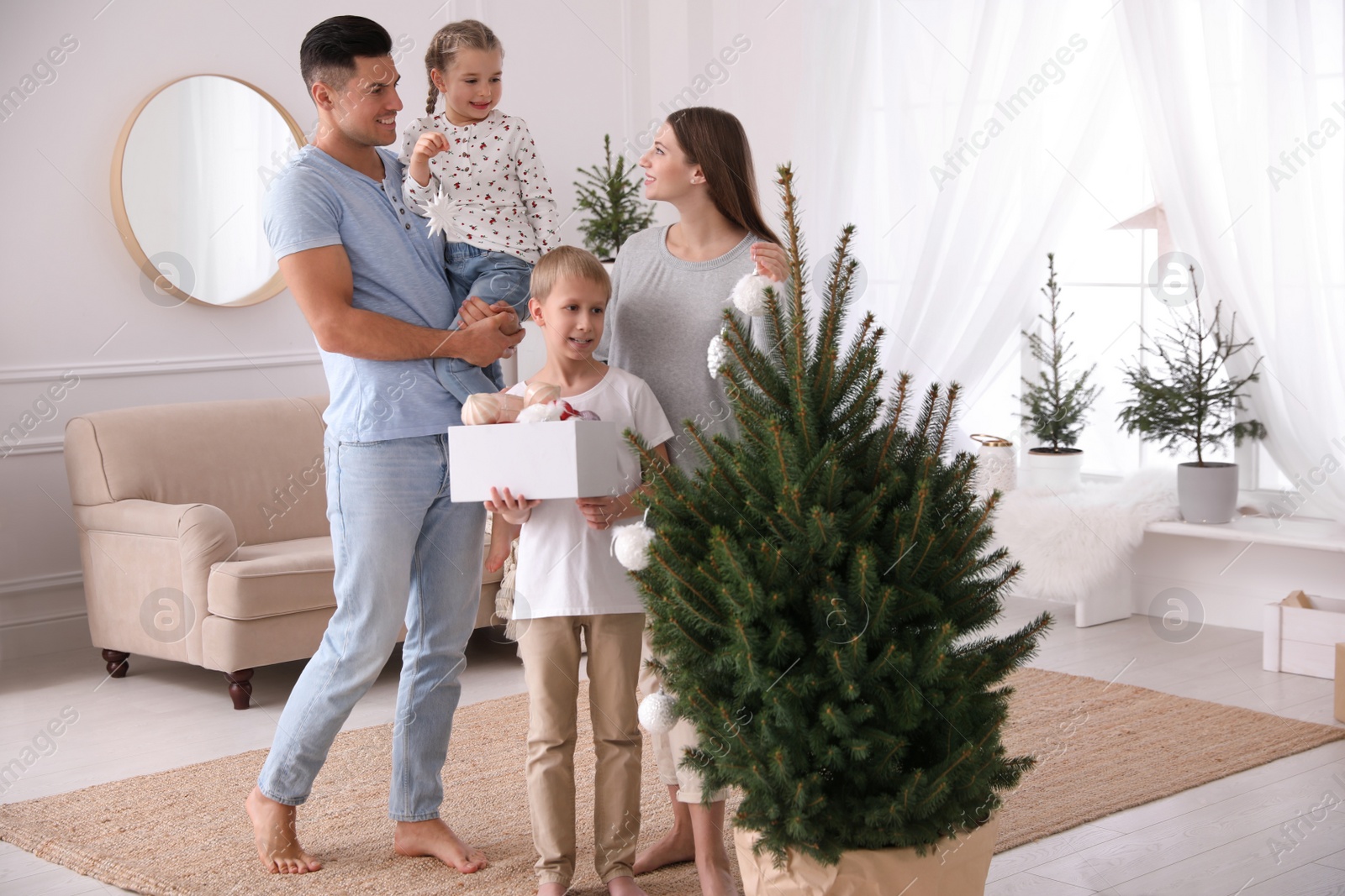 Photo of Happy family with cute children decorating Christmas tree together at home