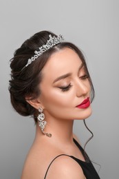 Photo of Beautiful young woman wearing luxurious tiara on light grey background