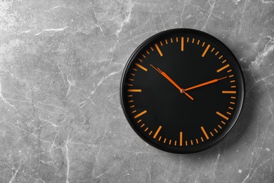 Photo of Modern clock on grey background, top view. Time management