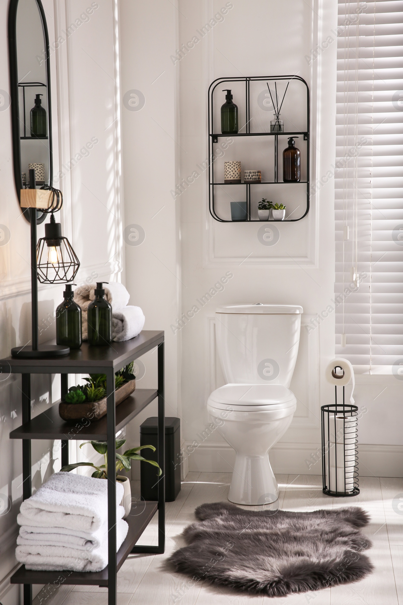 Photo of Modern toilet bowl in comfortable restroom. Interior design